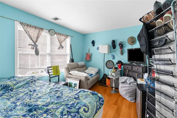 a bedroom with furniture and a flat screen tv