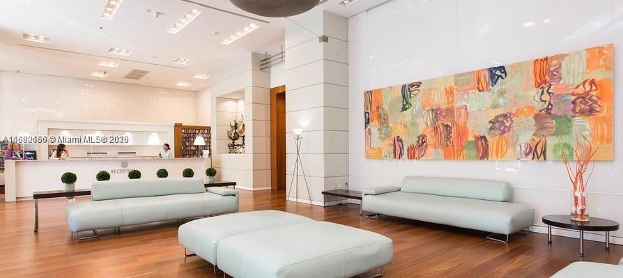 2889 McFarlane Road, Unit 909 Miami, FL 33133 - Photo 15 of 36 a living room with furniture and wooden floor