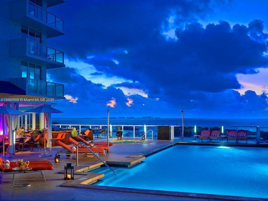 2889 McFarlane Road, Unit 909 Miami, FL 33133 - Photo 16 of 36 a view of a swimming pool with an outdoor seating