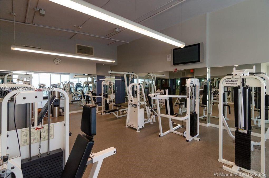 2889 McFarlane Road, Unit 909 Miami, FL 33133 - Photo 19 of 36 a view of a room with gym equipment