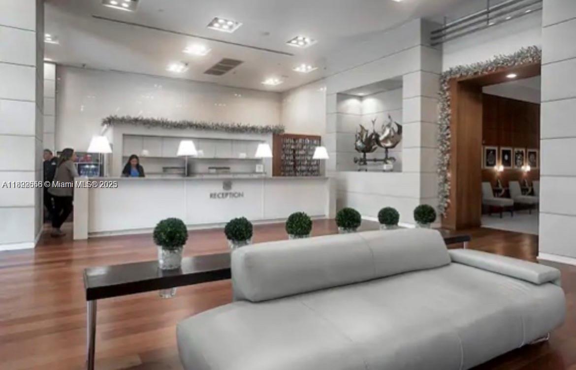 2889 McFarlane Road, Unit 909 Miami, FL 33133 - Photo 20 of 36 a living room with furniture and kitchen view