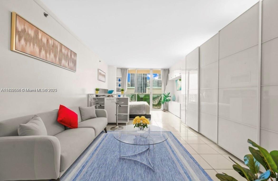 2889 McFarlane Road, Unit 909 Miami, FL 33133 - Photo 30 of 36 a living room with furniture and wooden floor