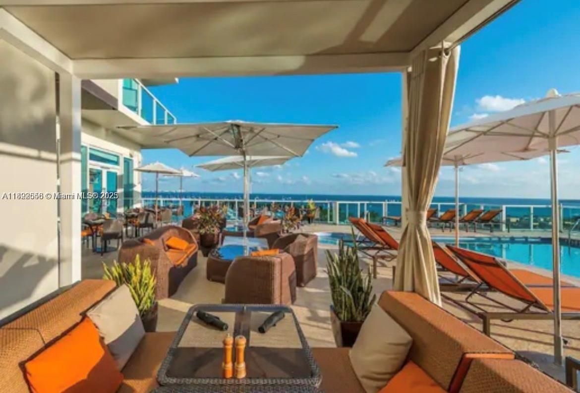 2889 McFarlane Road, Unit 909 Miami, FL 33133 - Photo 36 of 36 a view of a balcony with chairs and a patio