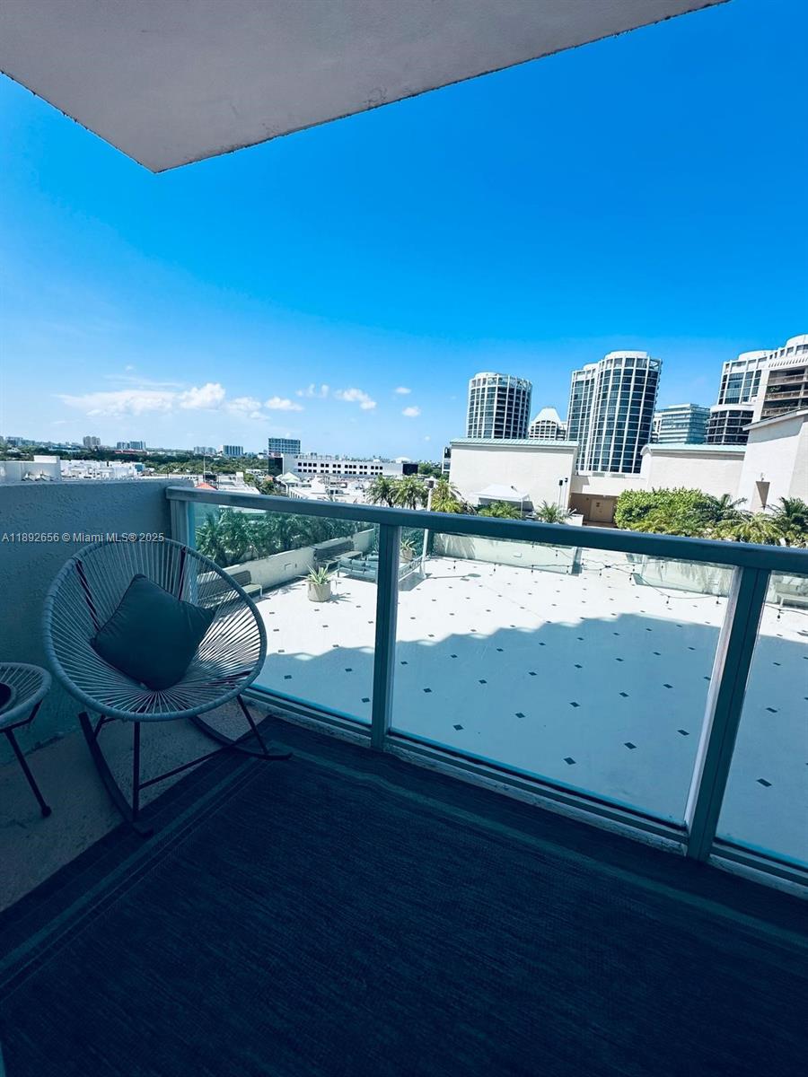 2889 McFarlane Road, Unit 909 Miami, FL 33133 - Photo 8 of 36 a view of a chair and table in the terrace