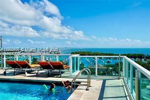 2889 McFarlane Road, Unit 909 Miami, FL 33133 - Photo 10 of 36 a view of swimming pool with lawn chairs and couches
