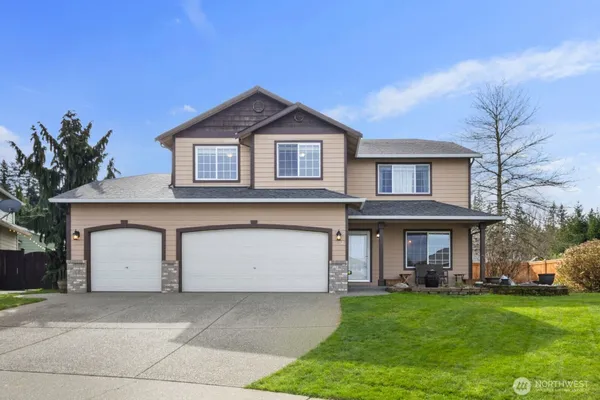 a front view of a house with a yard and garage