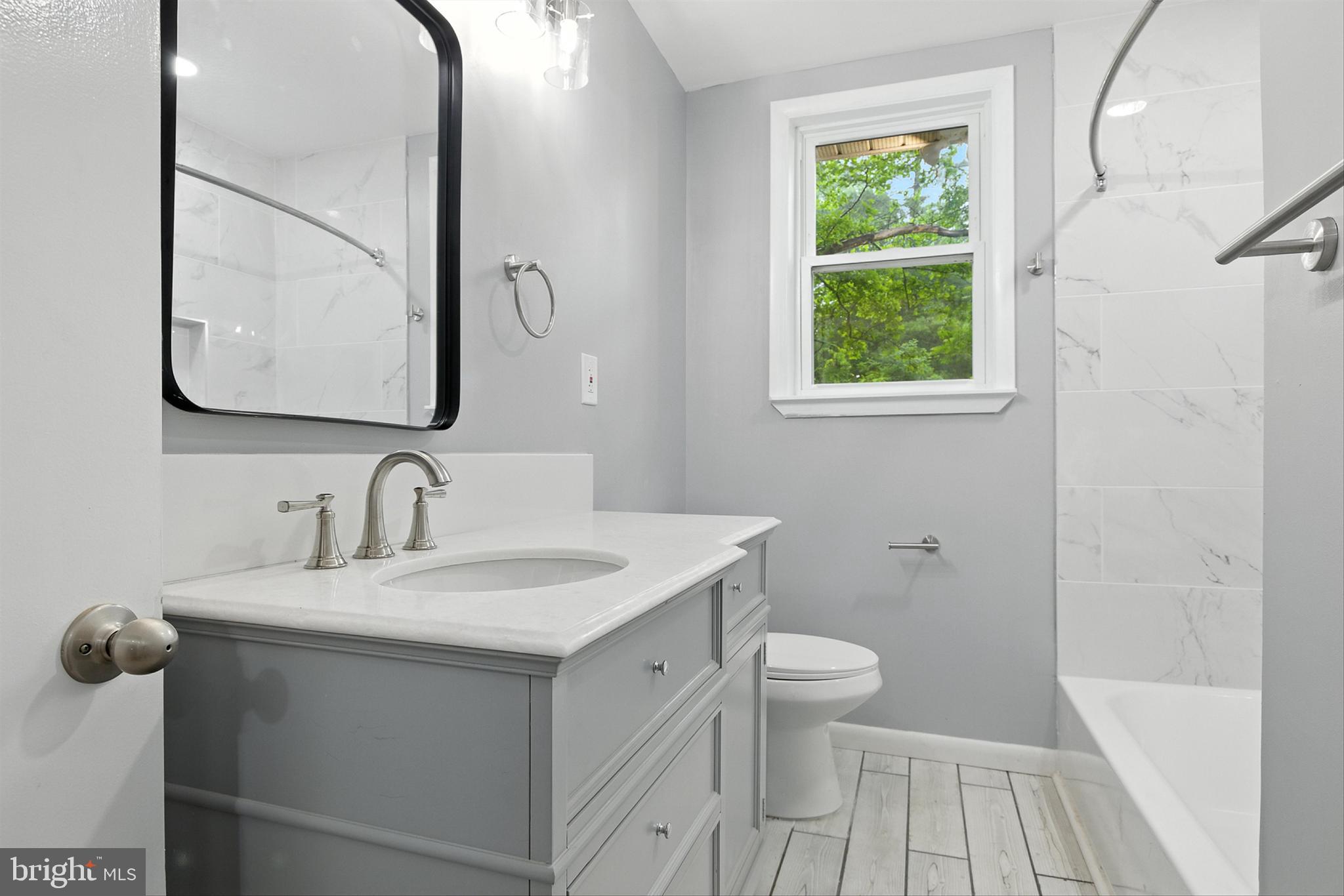 3126 Rices Lane Baltimore, MD 21244 - Photo 17 of 34 a bathroom with a sink a toilet and a mirror