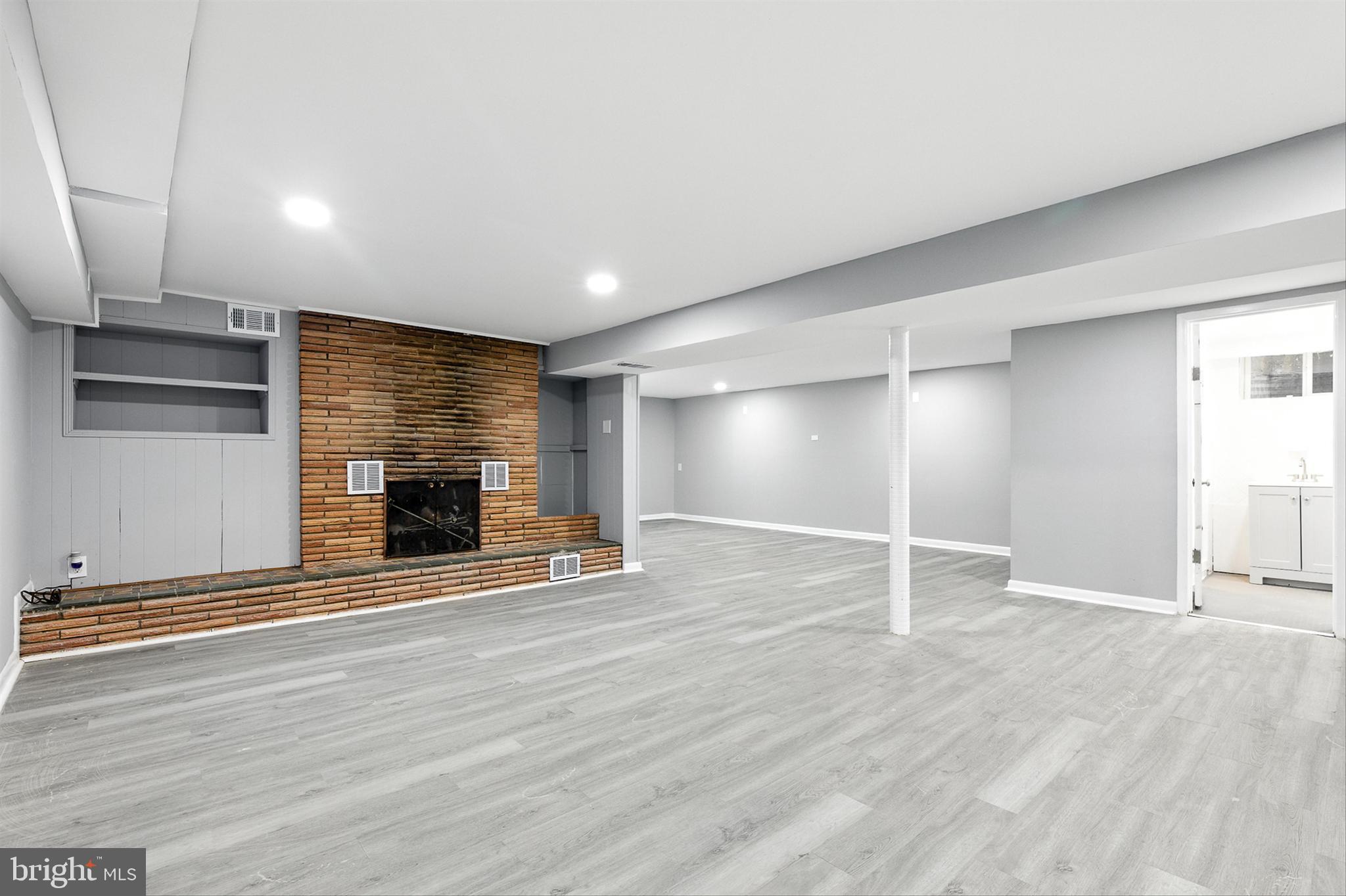 3126 Rices Lane Baltimore, MD 21244 - Photo 23 of 34 an empty room with wooden floor and fireplace