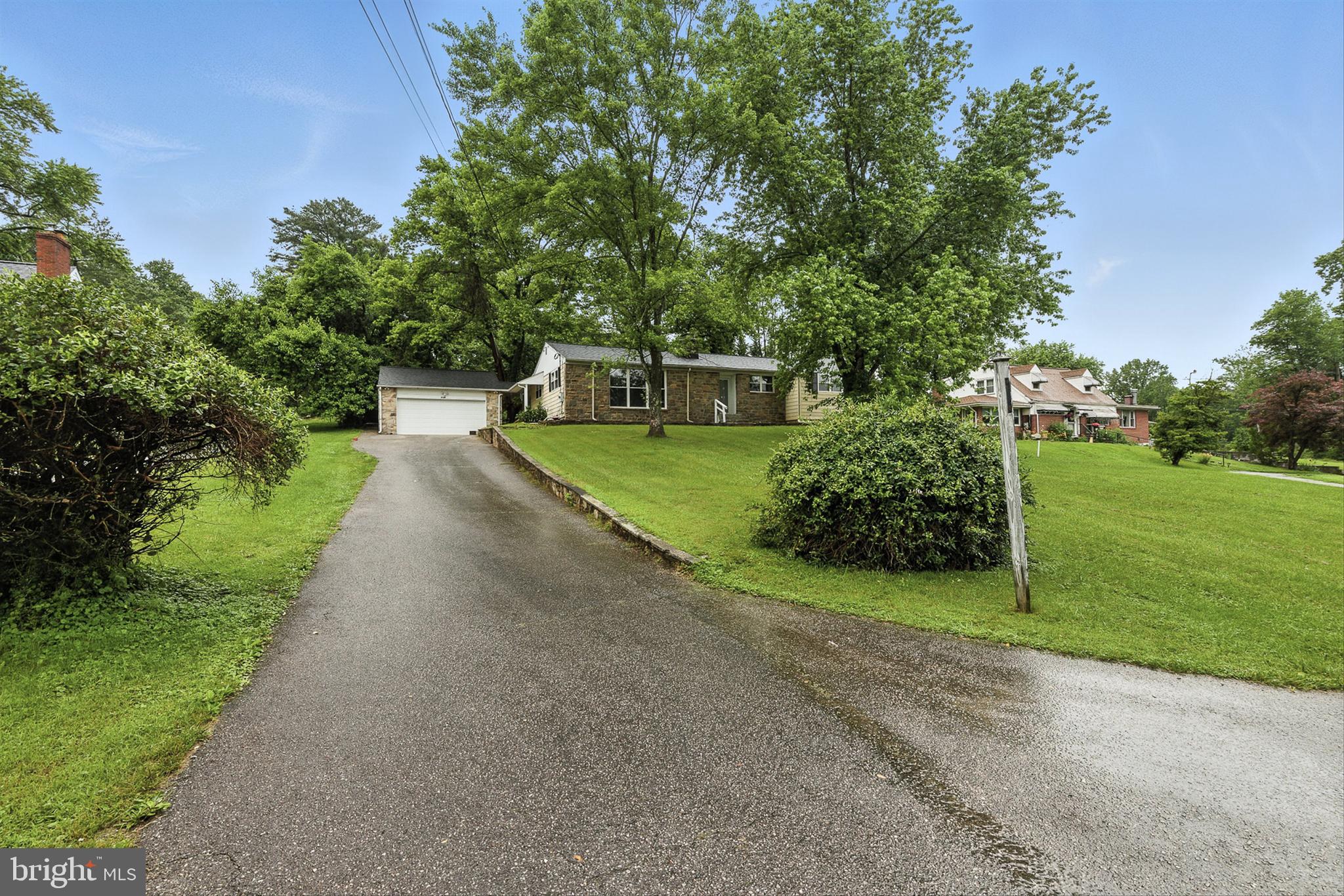 3126 Rices Lane Baltimore, MD 21244 - Photo 5 of 34 a view of a back yard with flower plants and large trees