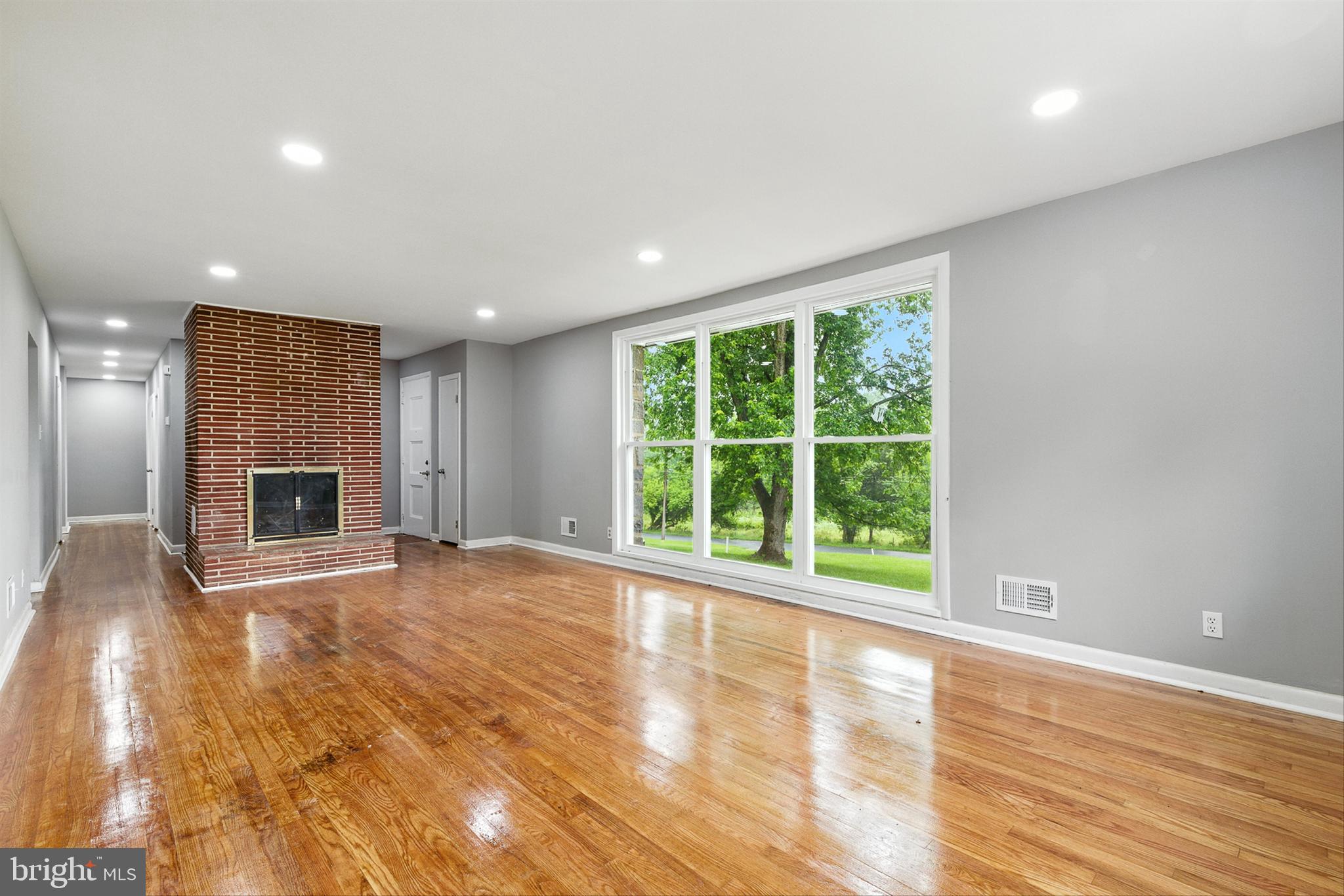 3126 Rices Lane Baltimore, MD 21244 - Photo 7 of 34 a view of an empty room with wooden floor and a window