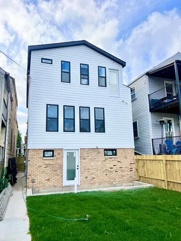 a front view of a house with a garden and yard