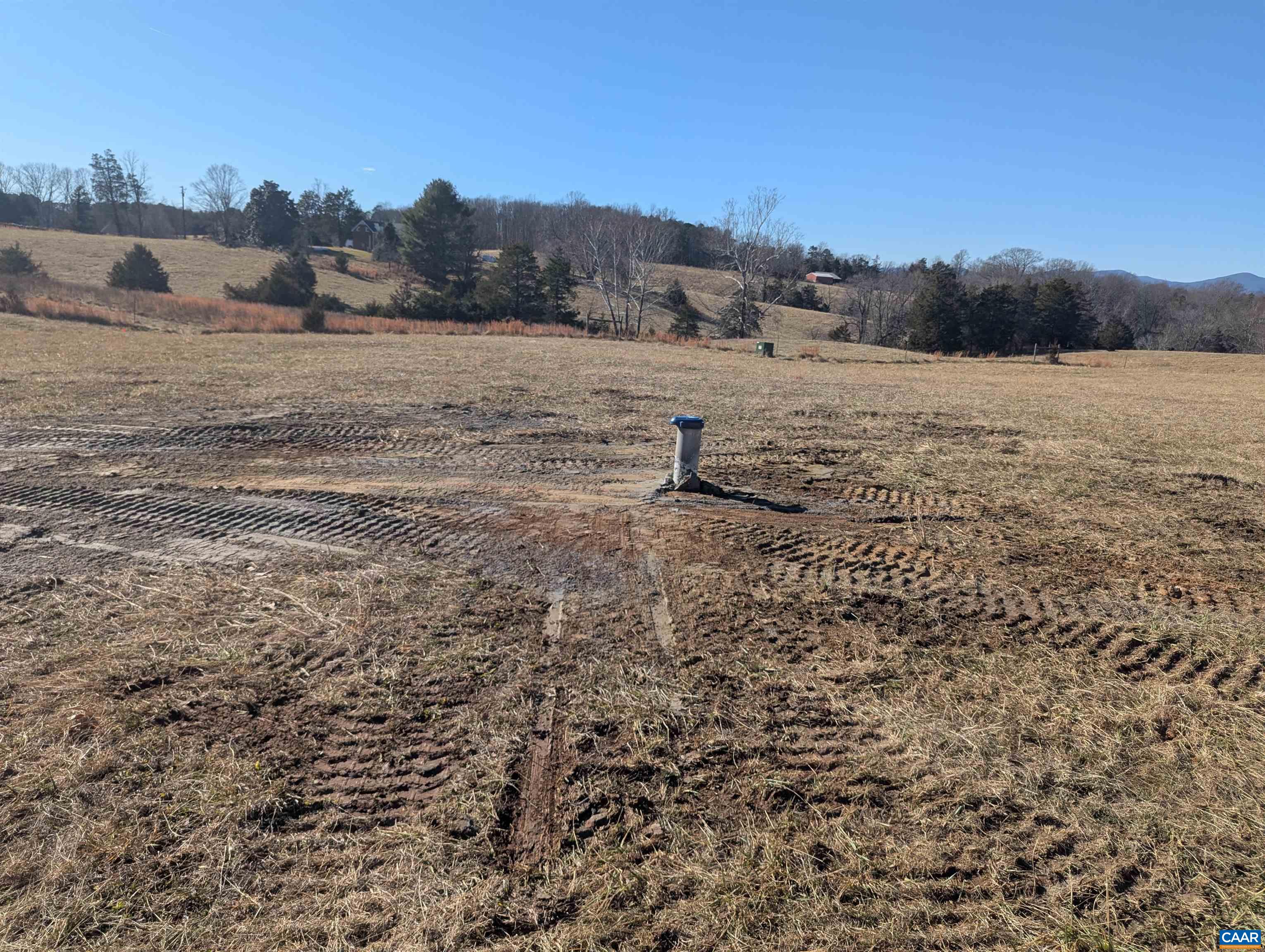 Undisclosed Address Ruckersville, VA 22968 - Photo 7 of 24 a view of a dry field with trees in the background
