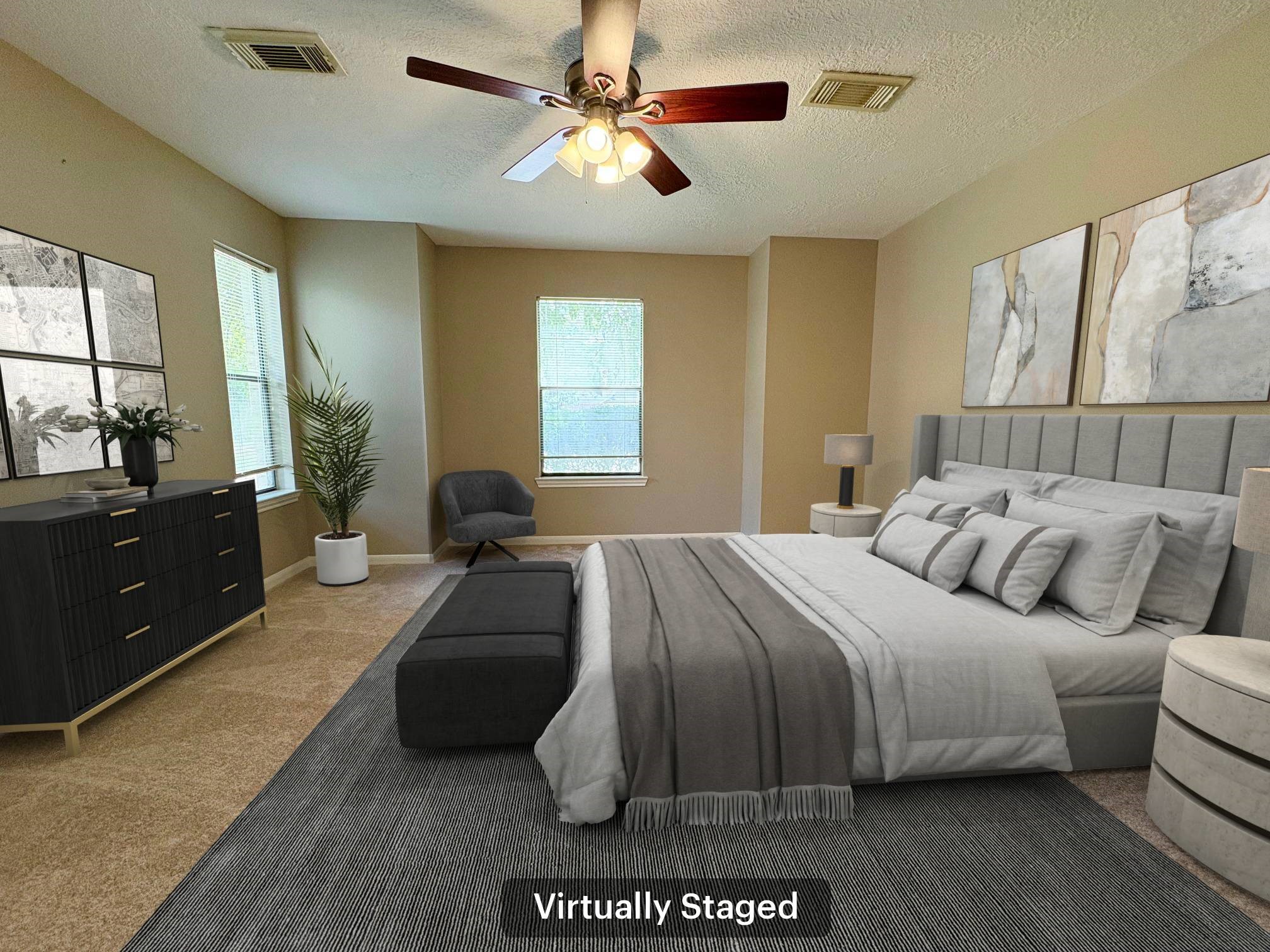 17706 Woodlode Lane Spring, TX 77379 - Photo 5 of 31 a spacious bedroom with a bed a couch and a large window