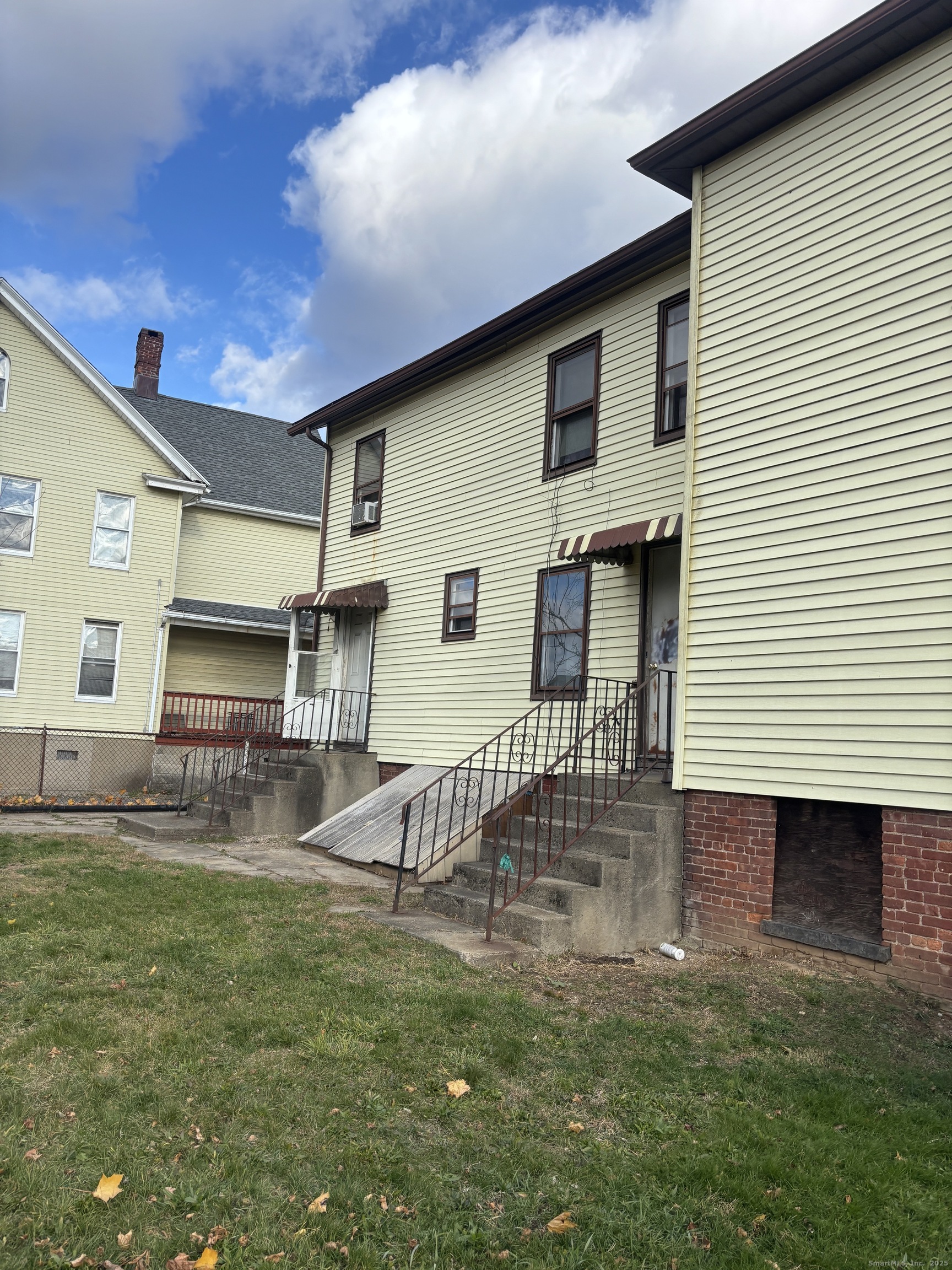 509 Pembroke Street Bridgeport, CT 06608 - Photo 2 of 25 a front view of a house with a yard