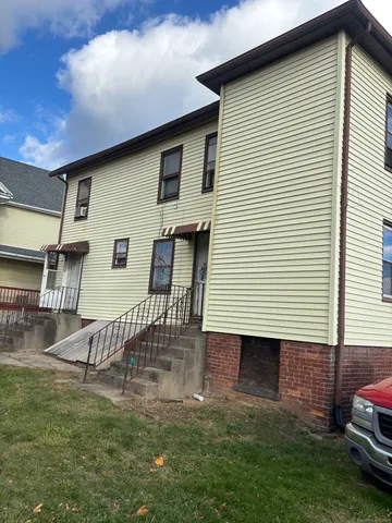 a backyard of a house with table and chairs
