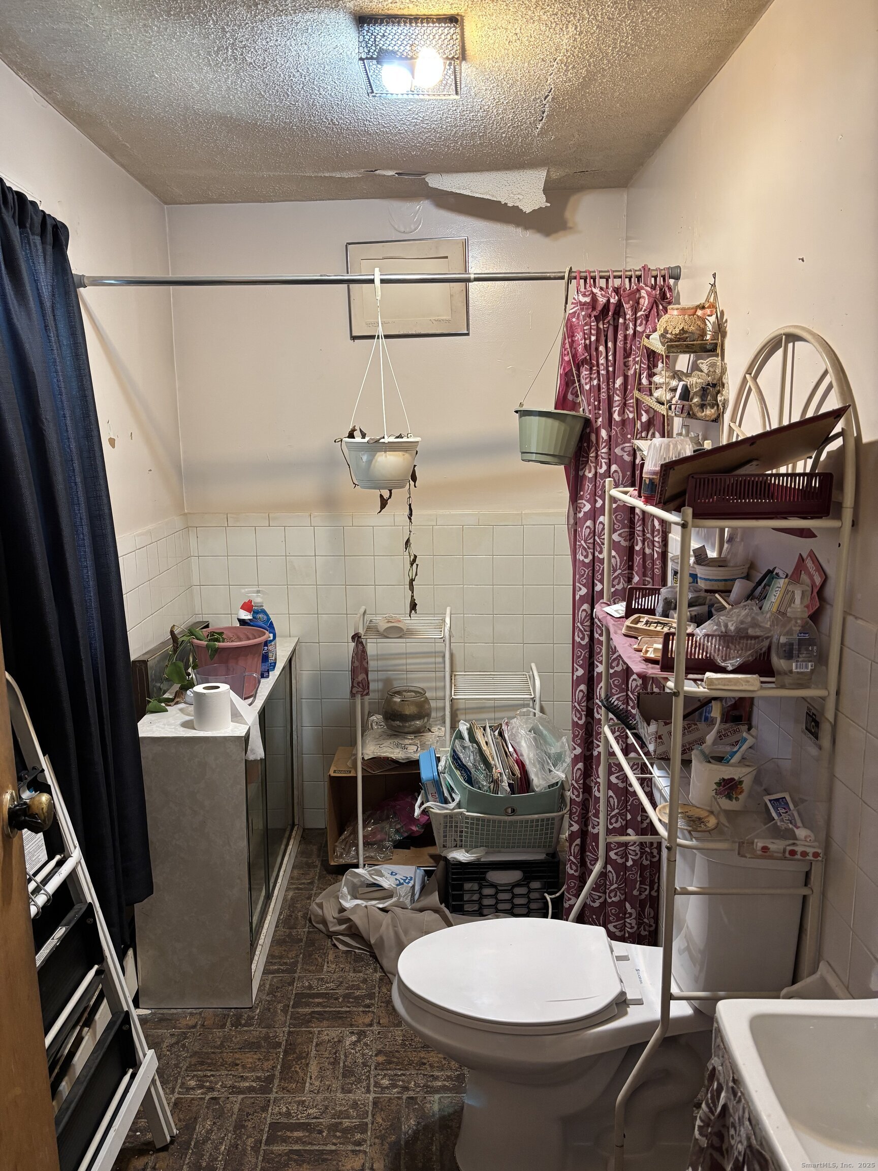 509 Pembroke Street Bridgeport, CT 06608 - Photo 9 of 25 a bathroom with a sink a toilet and shower