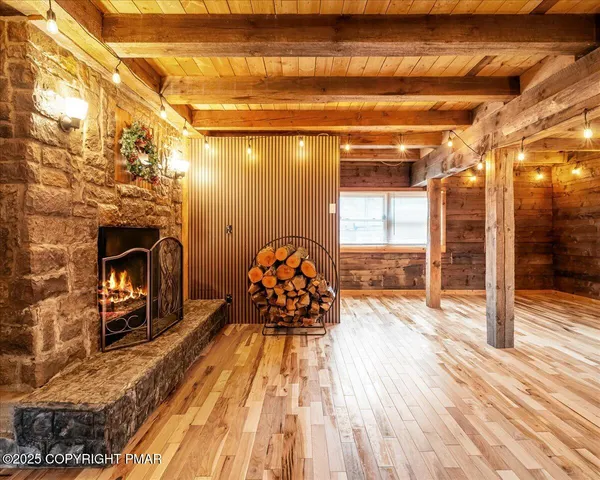 a spacious bedroom with a bed and wooden floor
