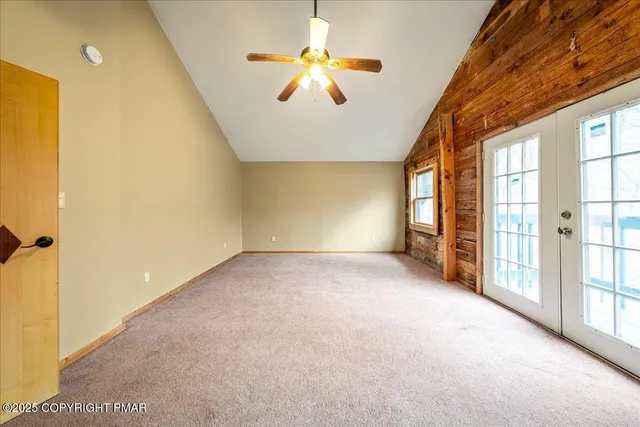 a view of a livingroom with a ceiling fan and window
