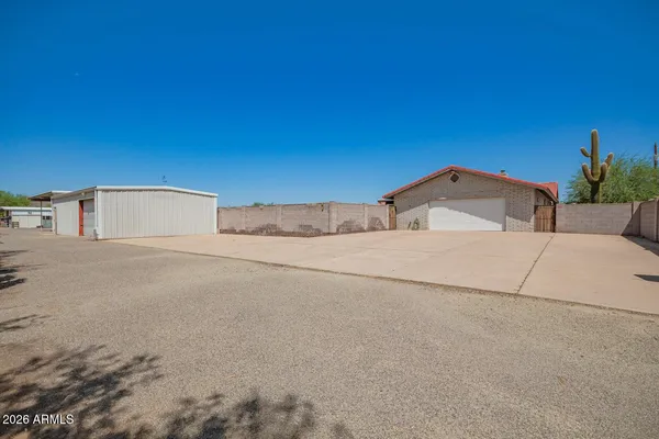 a view of a patio with a table under an umbrella
