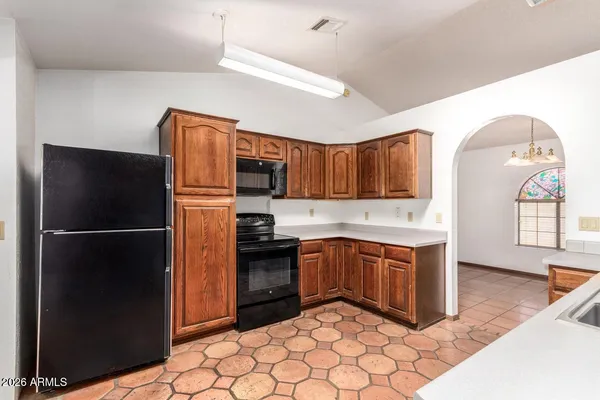 a kitchen with a sink cabinets and window