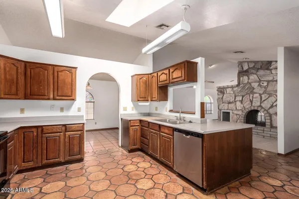 an empty room with chandelier fan