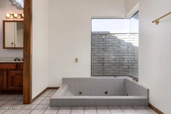 a spacious bathroom with a toilet sink and mirror