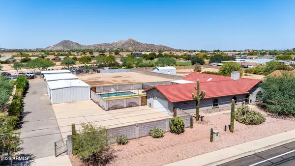 a view of a house with porch and a yard