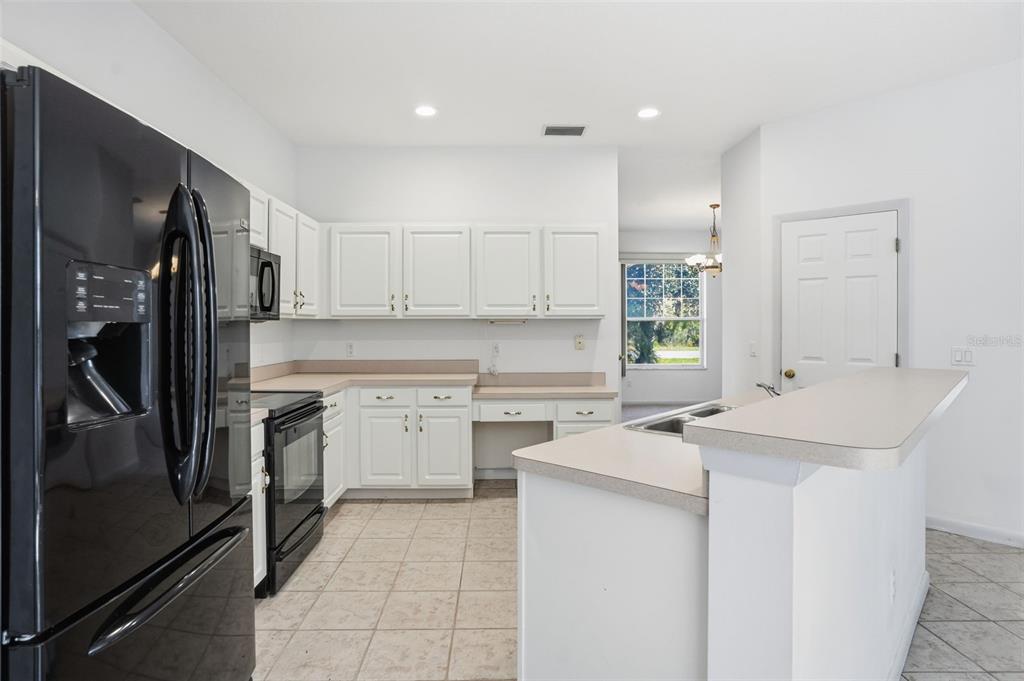 16 Nephthytis Court Homosassa, FL 34446 - Photo 2 of 45 a kitchen with a sink stove and refrigerator
