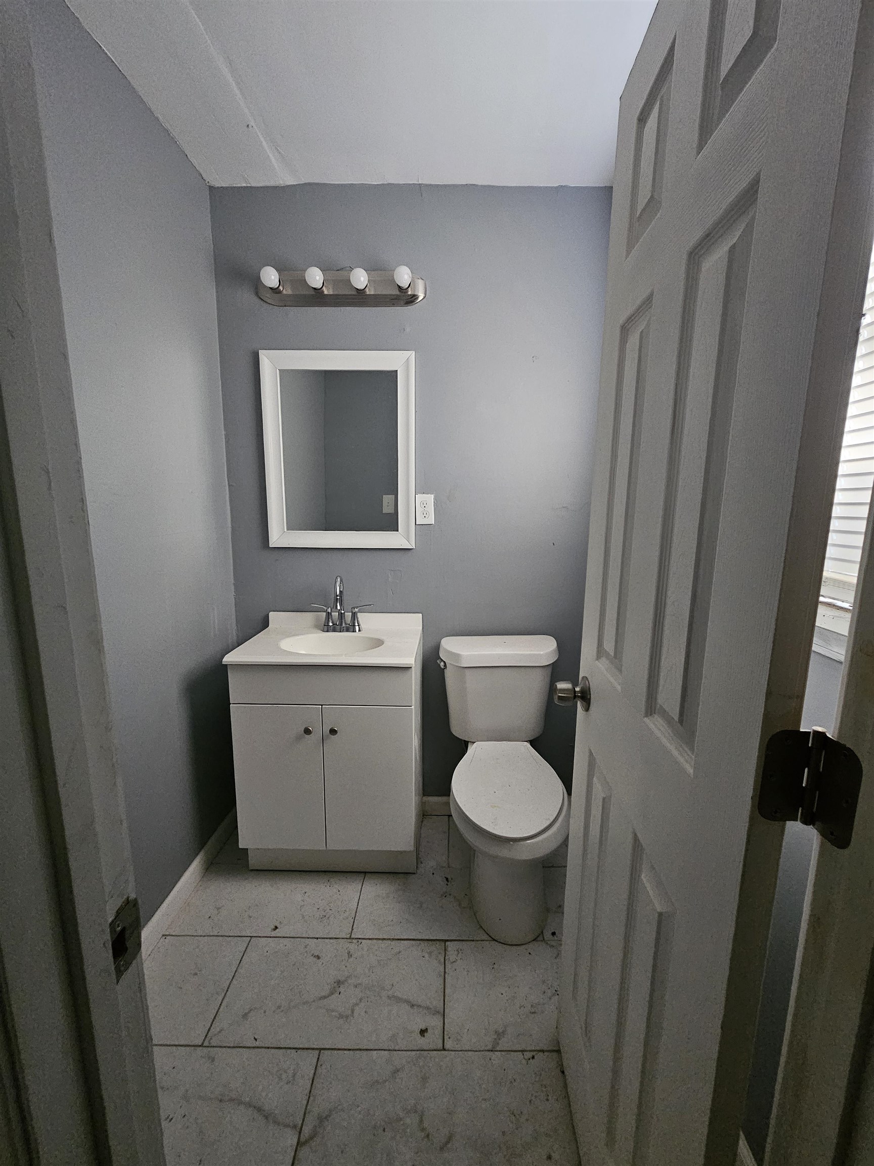 2059 Swift Street Memphis, TN 38109 - Photo 11 of 12 Bathroom with a white vanity, integrated sink, and chrome faucet