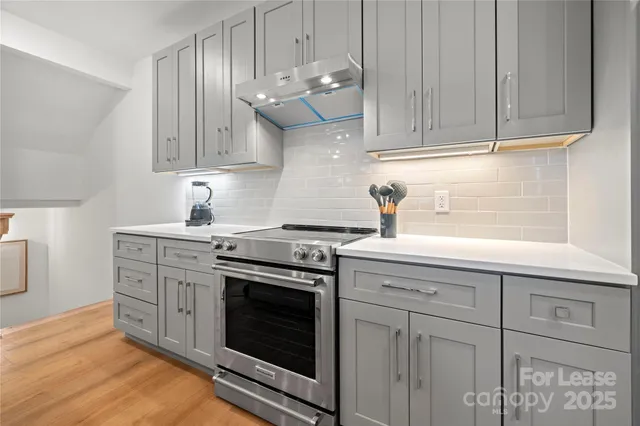 a kitchen with cabinets appliances and a sink