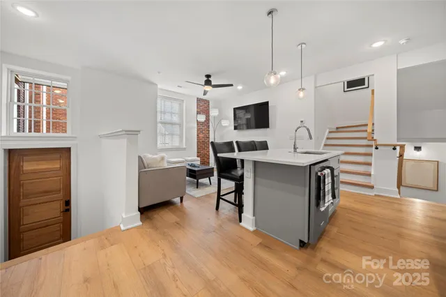 a large white kitchen with a large window and stainless steel appliances