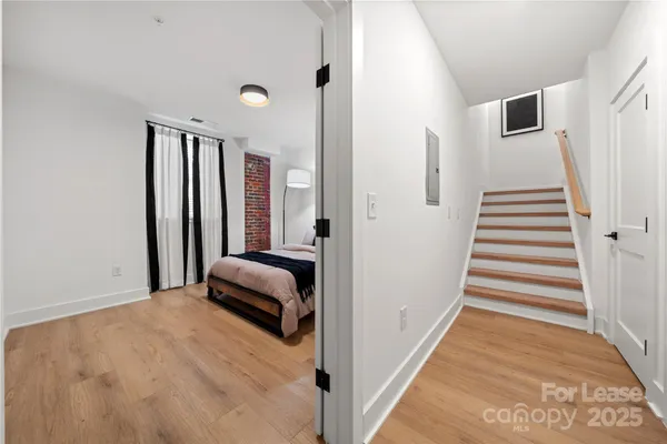 a bedroom with a bed and a large mirror