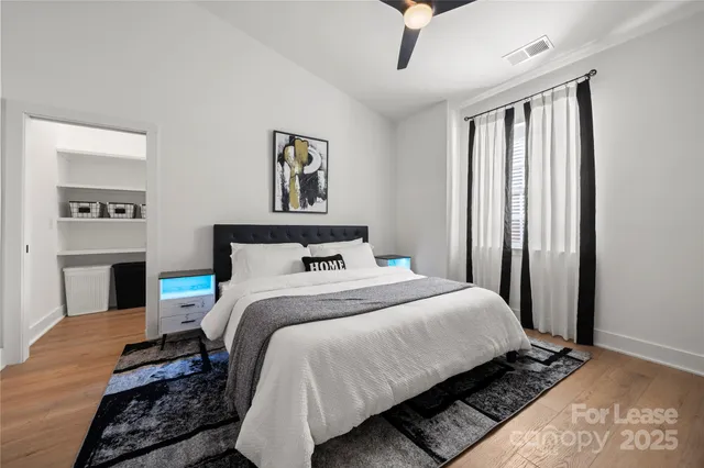 a bedroom with a large bed and a window