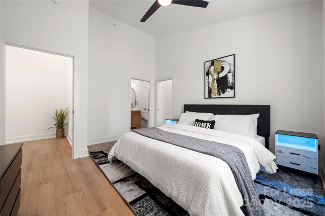 a bedroom with a bed and a painting on the wall