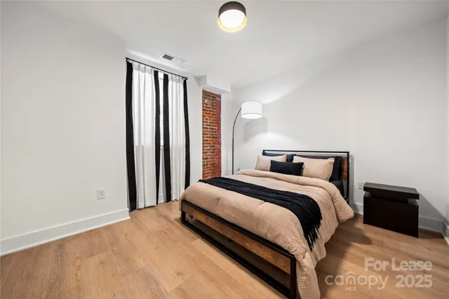 a view of a livingroom with wooden floor and staircase