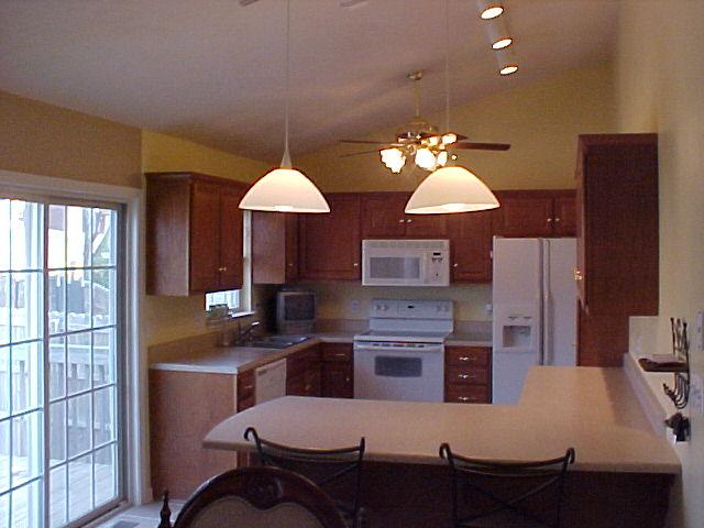 1762 Meadows Road Vinton, VA 24179 - Photo 5 of 12 a kitchen with stainless steel appliances granite countertop a table chairs and a refrigerator