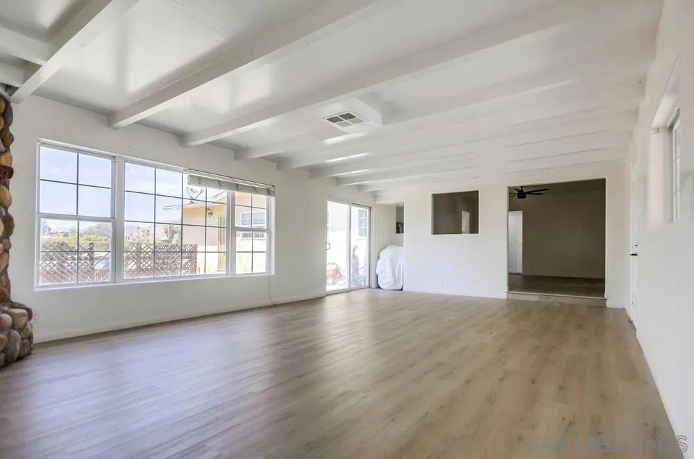 12224 Lemon Crest Drive Lakeside, CA 92040 - Photo 11 of 61 an empty room with wooden floor and windows