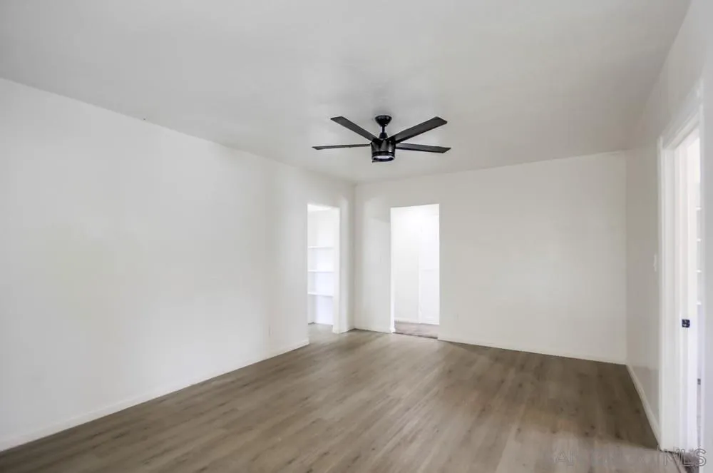12224 Lemon Crest Drive Lakeside, CA 92040 - Photo 13 of 61 a view of a room with wooden floor and a ceiling fan