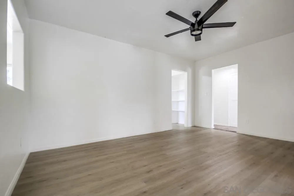 12224 Lemon Crest Drive Lakeside, CA 92040 - Photo 14 of 61 an empty room with wooden floor and windows