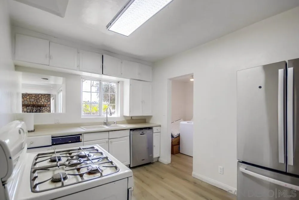 12224 Lemon Crest Drive Lakeside, CA 92040 - Photo 17 of 61 a kitchen with stainless steel appliances a stove a sink and a refrigerator