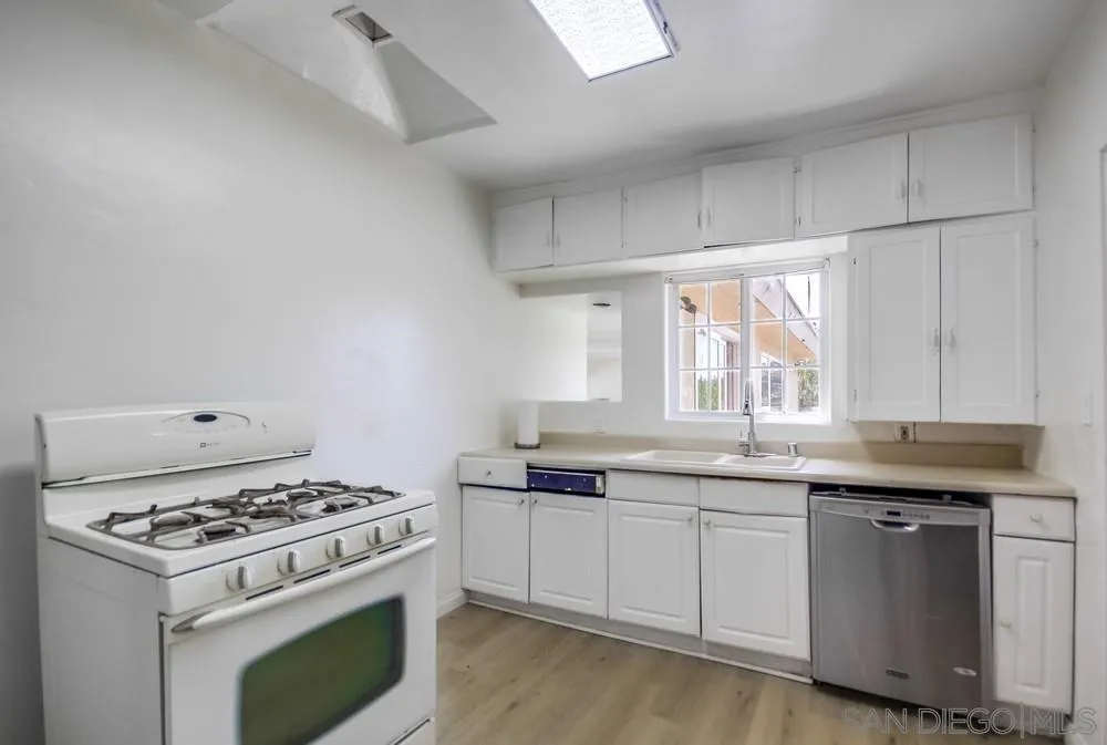 12224 Lemon Crest Drive Lakeside, CA 92040 - Photo 19 of 61 a kitchen with granite countertop a sink a stove and cabinets