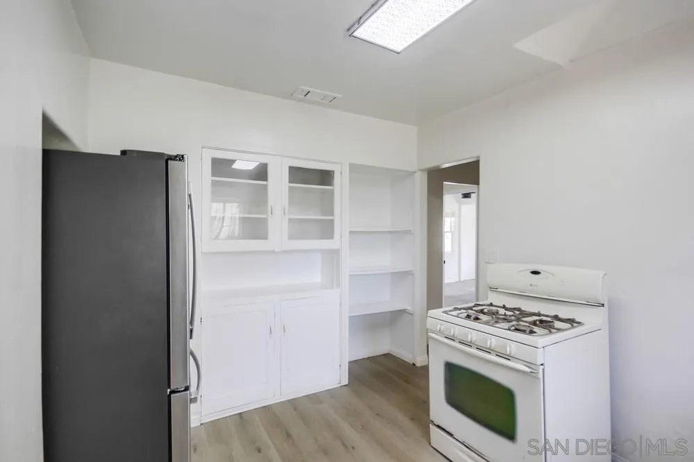 12224 Lemon Crest Drive Lakeside, CA 92040 - Photo 21 of 61 a kitchen with granite countertop a stove and a refrigerator
