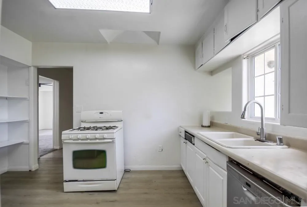 12224 Lemon Crest Drive Lakeside, CA 92040 - Photo 22 of 61 a kitchen with a stove top oven sink and window