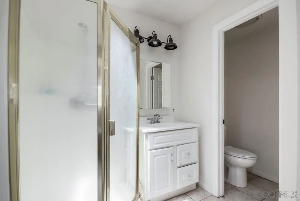 12224 Lemon Crest Drive Lakeside, CA 92040 - Photo 28 of 61 a bathroom with a granite countertop toilet sink and mirror