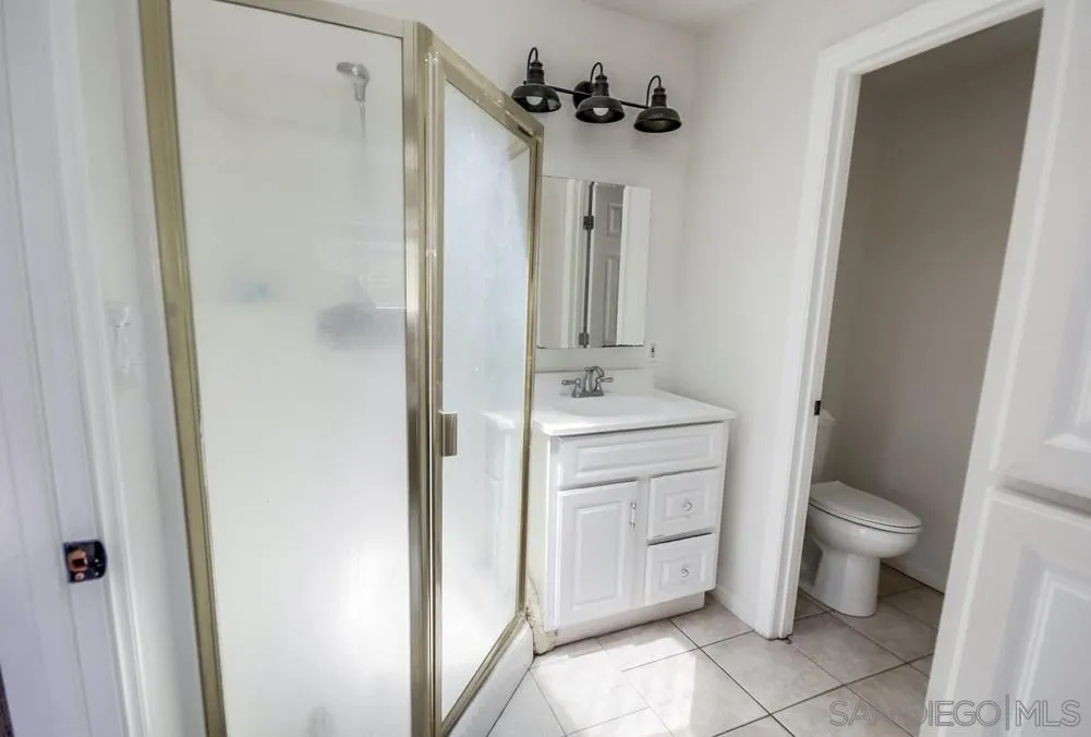 12224 Lemon Crest Drive Lakeside, CA 92040 - Photo 29 of 61 a bathroom with a toilet sink and mirror