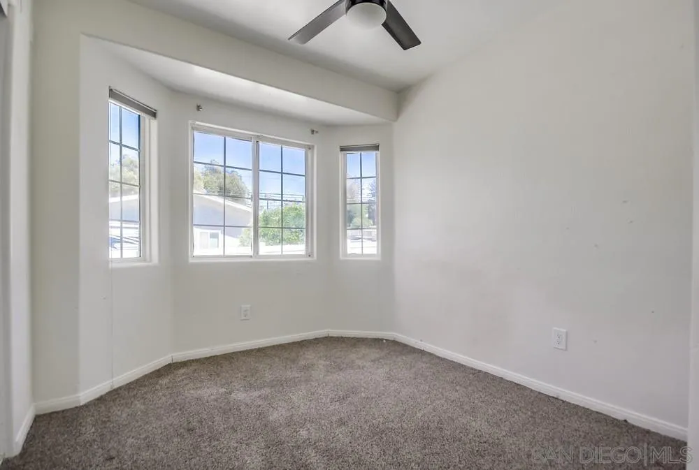 12224 Lemon Crest Drive Lakeside, CA 92040 - Photo 37 of 61 an empty room with windows and fan