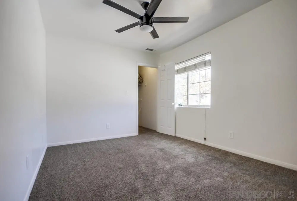 12224 Lemon Crest Drive Lakeside, CA 92040 - Photo 40 of 61 an empty room with windows and fan