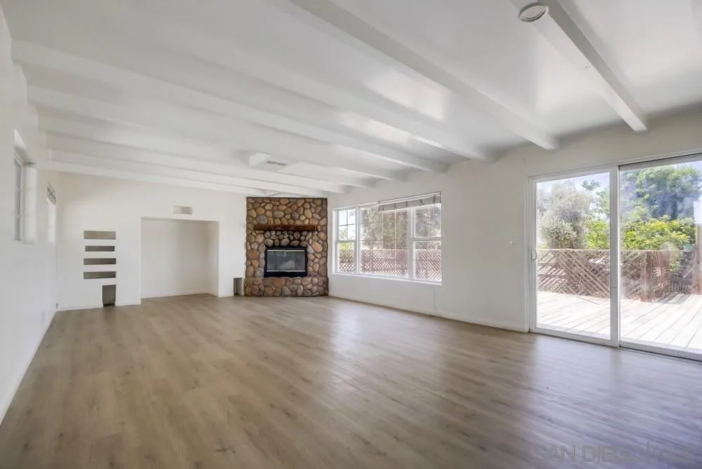 12224 Lemon Crest Drive Lakeside, CA 92040 - Photo 9 of 61 an empty room with wooden floor and windows