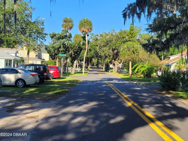 a view of street with tall trees