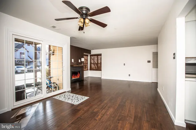 a view of an empty room with wooden floor